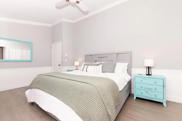 a bedroom with a bed and a night stand