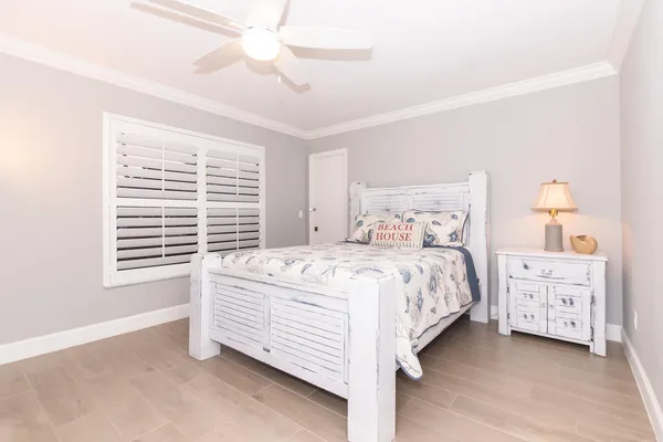 a bedroom with a bed dresser and a window