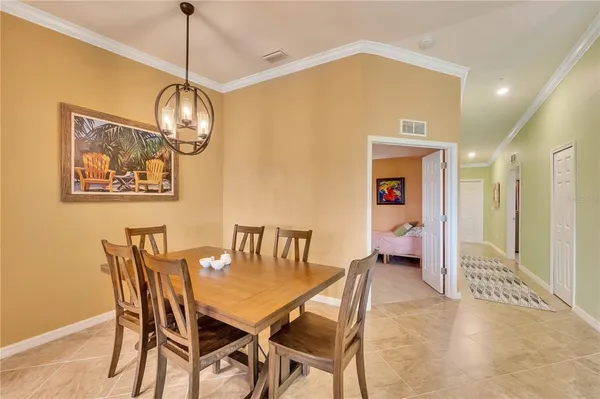a view of a dining room with furniture and windows