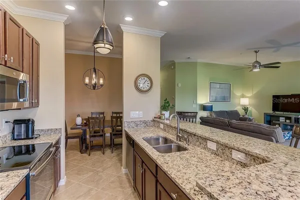 a spacious bathroom with a granite countertop sink a mirror and shower