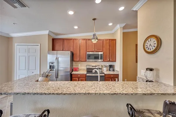 a bedroom with a bed and a flat tv screen on dresser
