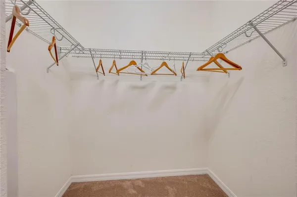 a view of a house with a yard and palm trees