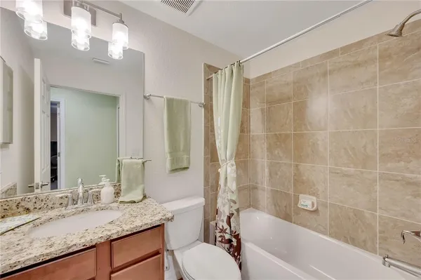 a view of a big yard with table and chairs under an umbrella
