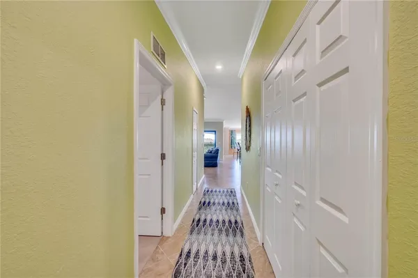 a view of a house with a big yard and large trees