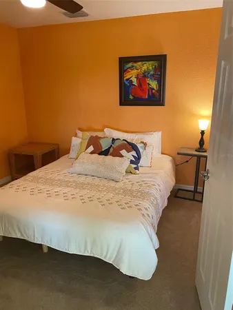 a view of a room with lots of wooden floor and a chandelier