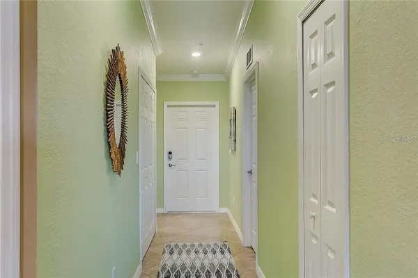 a living room with furniture and kitchen view