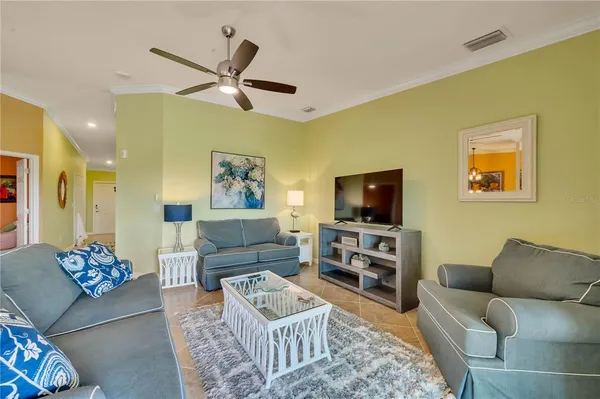 a living room with furniture and a floor to ceiling window