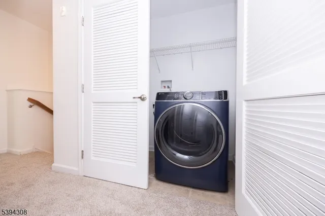 a view of a hallway with washer and dryer