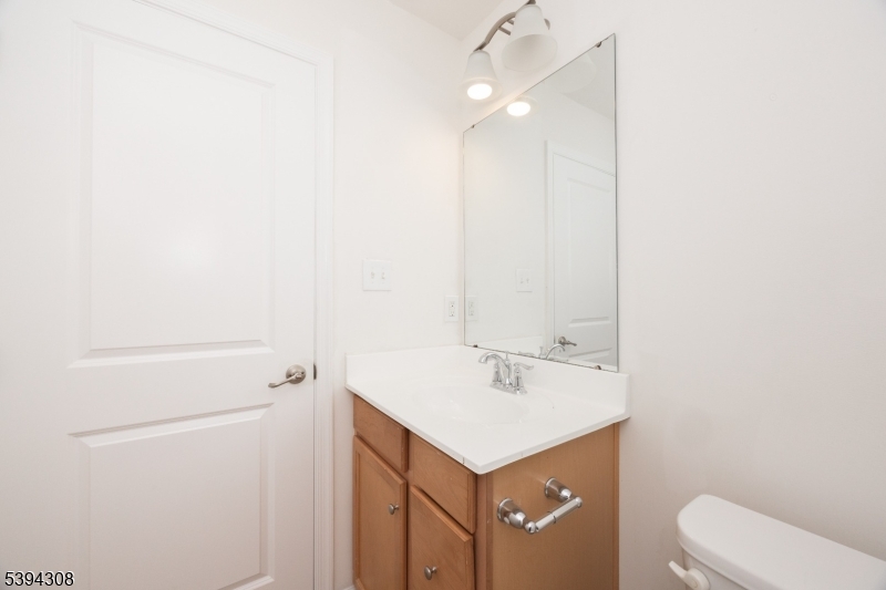 11 Panfili Lane Hamilton, NJ 08610 - Photo 20 of 29 a bathroom with a sink a toilet and vanity