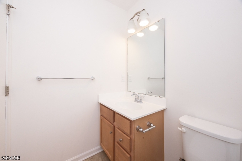 11 Panfili Lane Hamilton, NJ 08610 - Photo 24 of 29 a bathroom with a sink a toilet and vanity