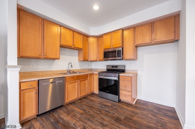 11 Panfili Lane Hamilton, NJ 08610 - Photo 3 of 29 a kitchen with stainless steel appliances granite countertop a stove a sink and a microwave