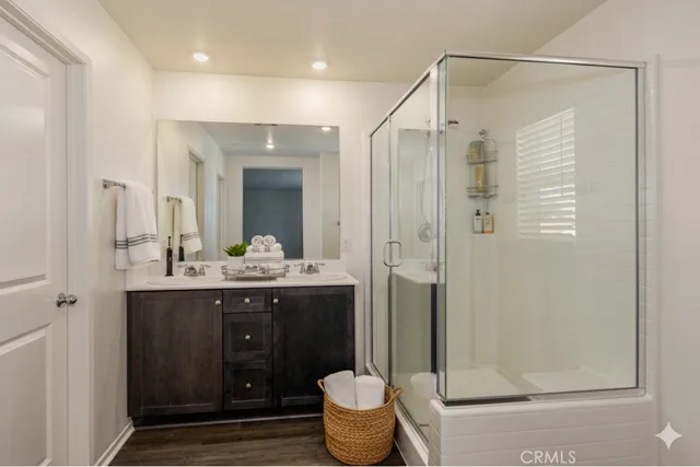 a bathroom with a granite countertop sink a toilet and shower