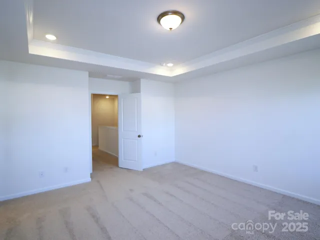 an empty room with wooden floor and mirror