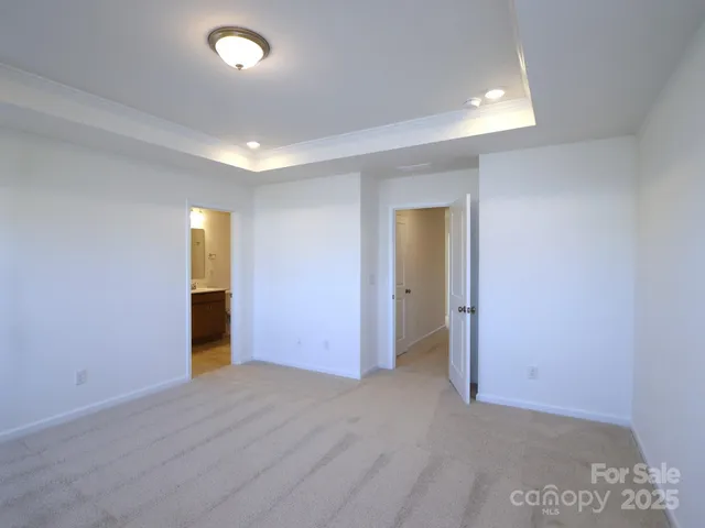 an empty room with wooden floor and natural light