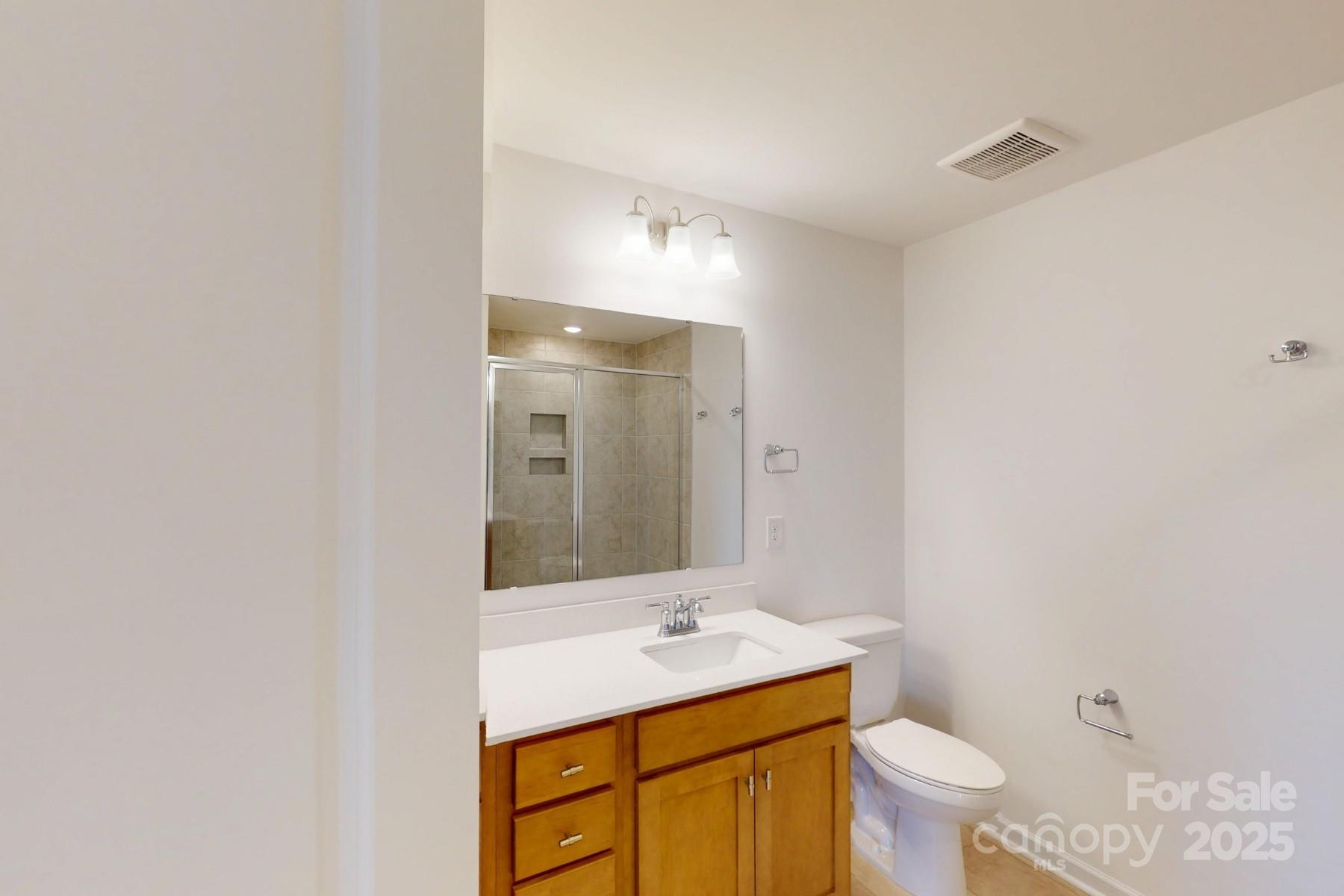 1018 Overbrook Place Wingate, NC 28174 - Photo 19 of 23 a bathroom with a sink toilet and mirror