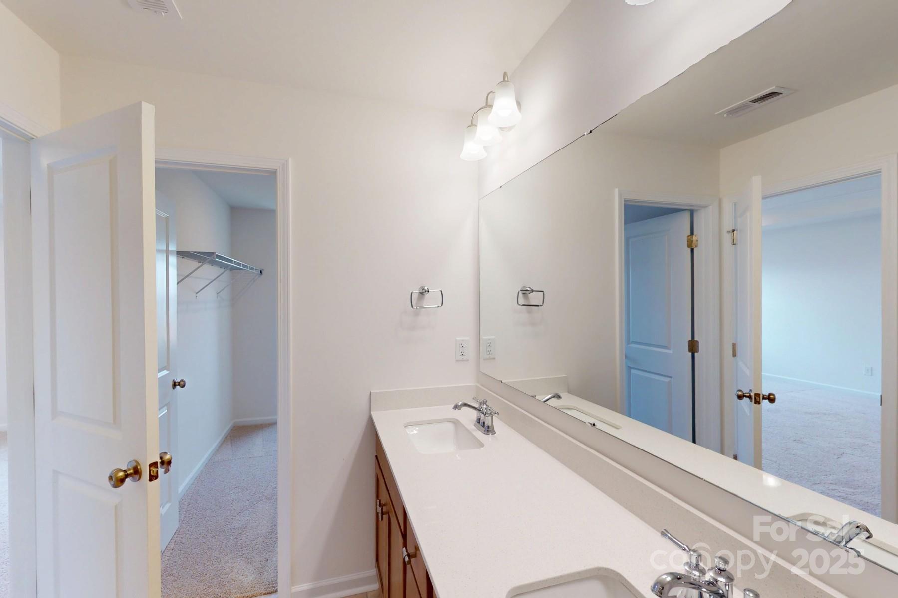 1018 Overbrook Place Wingate, NC 28174 - Photo 20 of 23 a bathroom with a sink a mirror and a shower