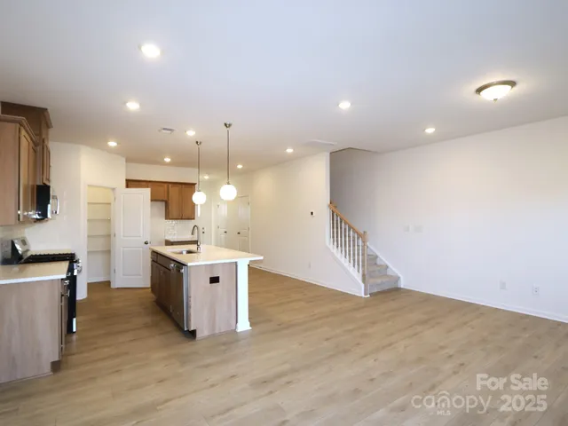 a large kitchen with a sink and a stove top oven