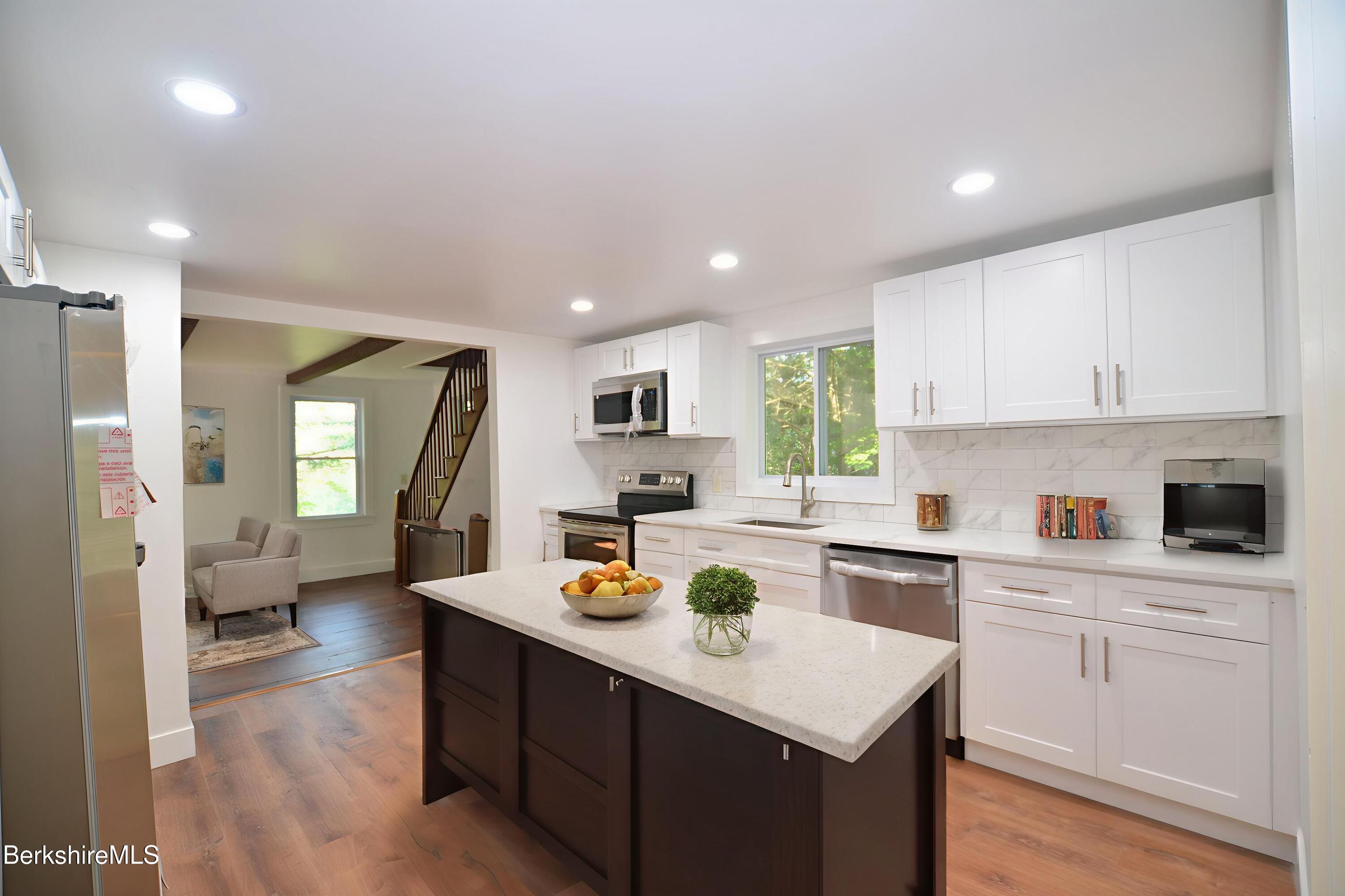 190 Willow Street Lee, MA 01260 - Photo 14 of 48 a open kitchen with sink cabinets and wooden floor