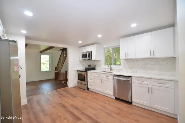 a kitchen with a stove a sink and a microwave