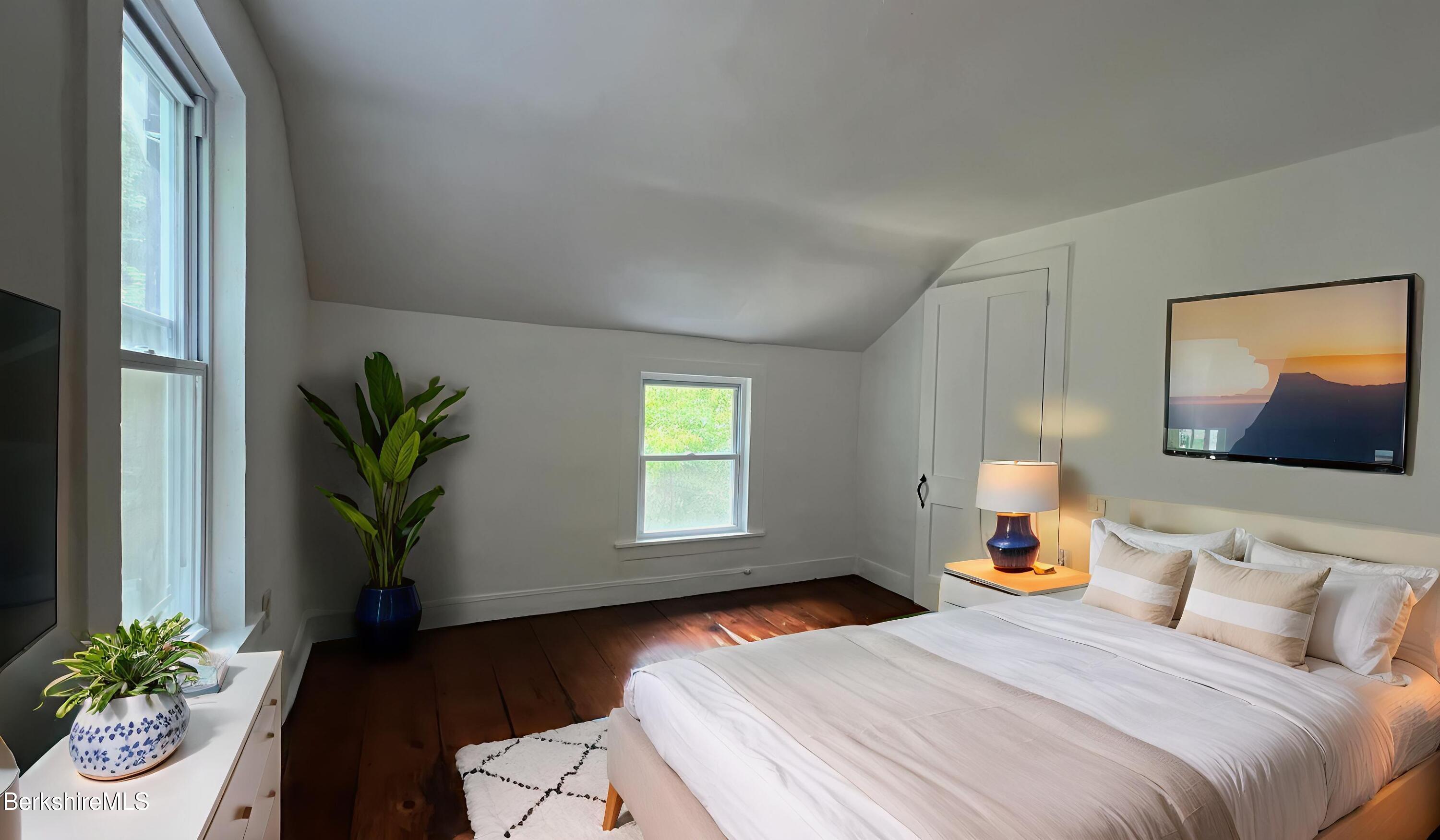190 Willow Street Lee, MA 01260 - Photo 29 of 48 a bedroom with a bed and a potted plant