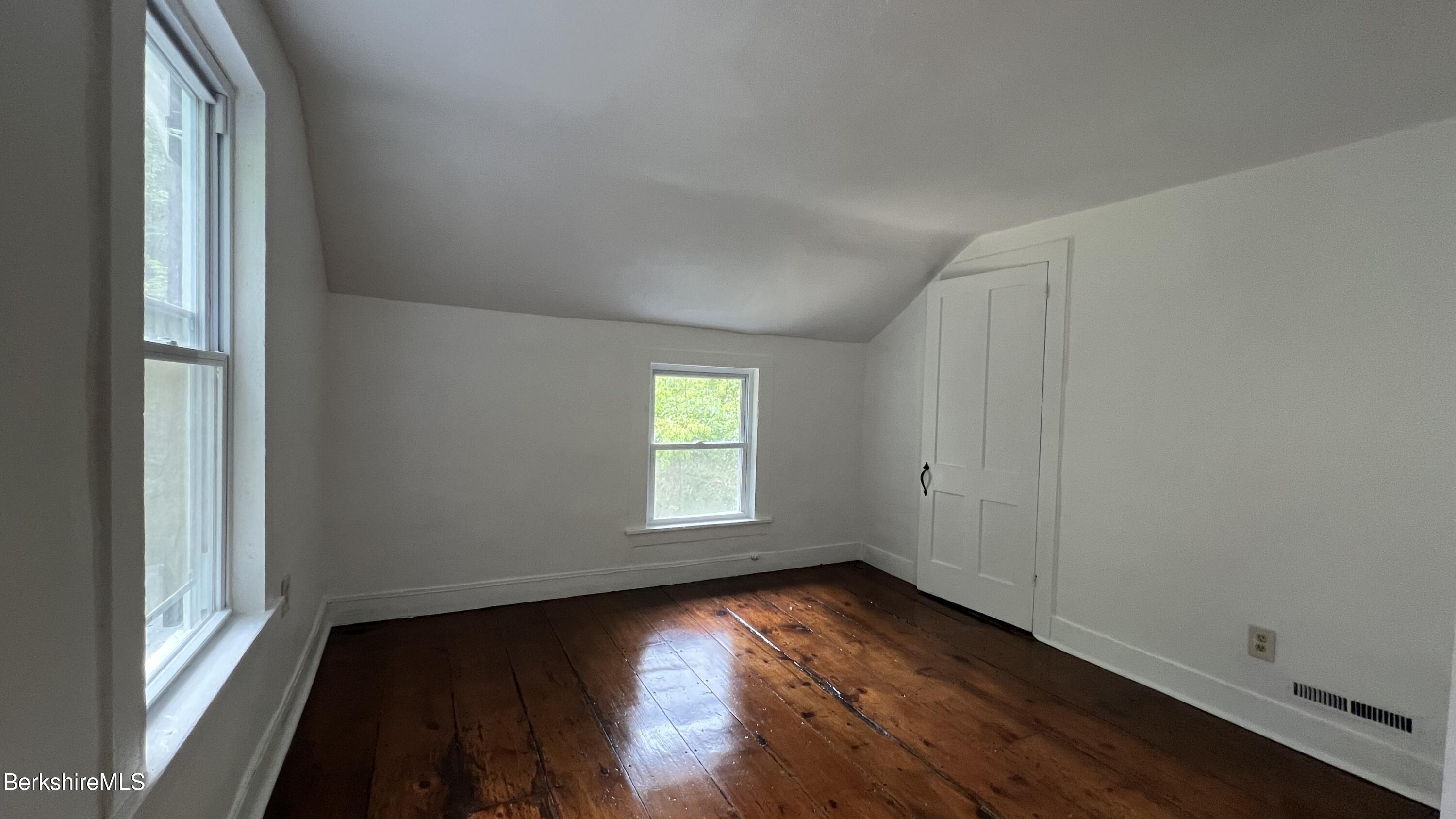 190 Willow Street Lee, MA 01260 - Photo 30 of 48 an empty room with wooden floor and windows