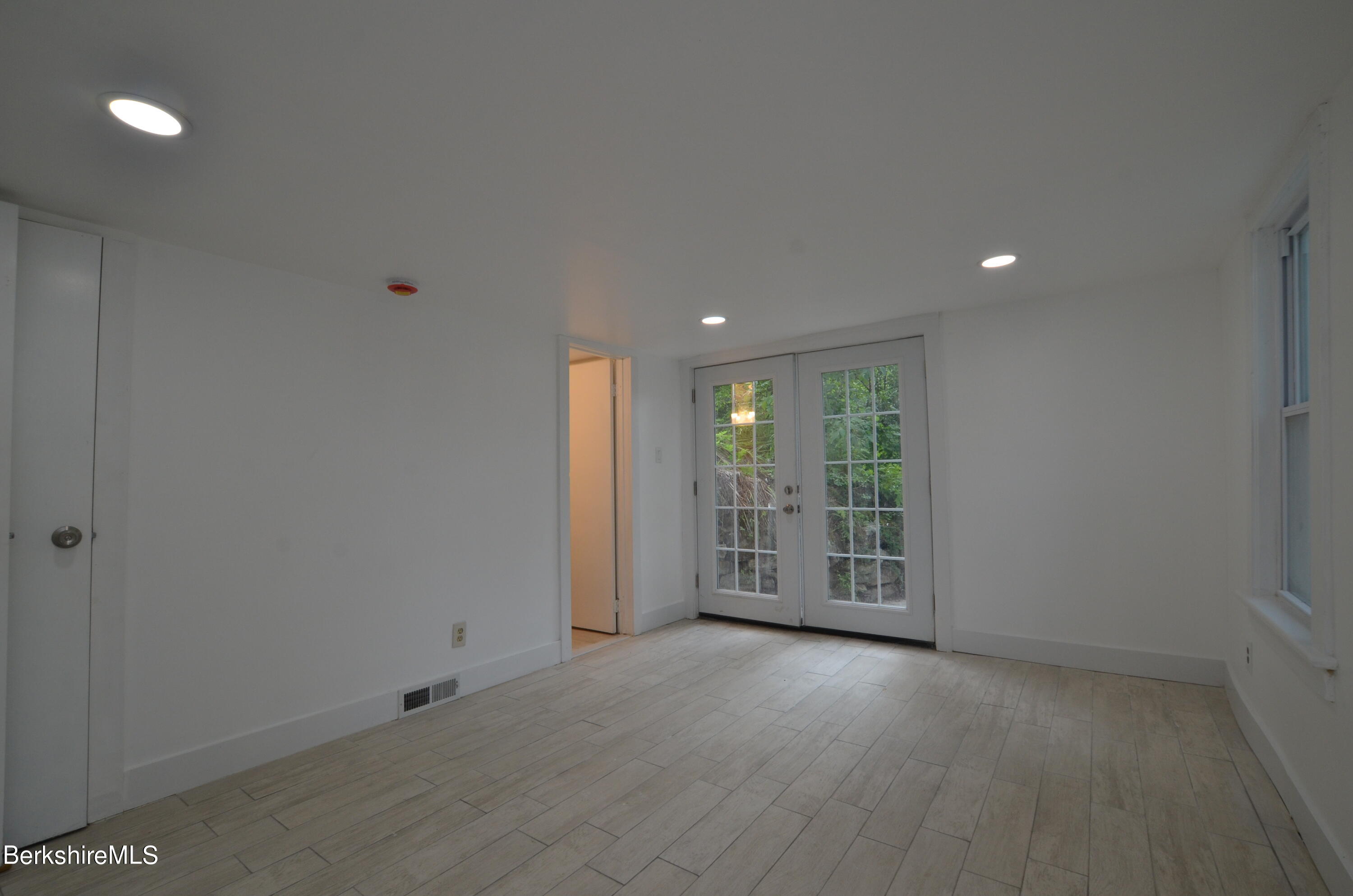 190 Willow Street Lee, MA 01260 - Photo 34 of 41 a view of an empty room with wooden floor and a window