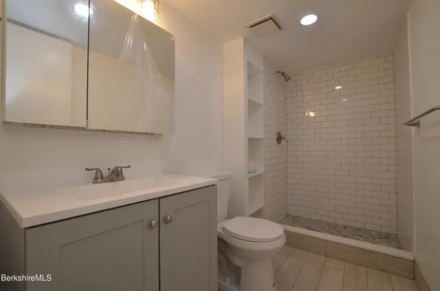 an aerial view of residential house with outdoor space and trees around