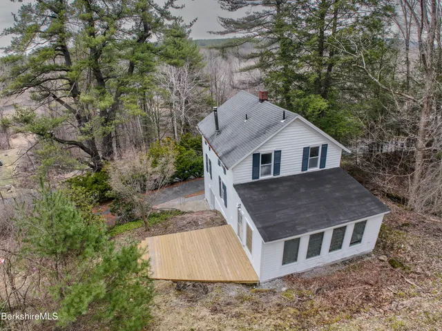 a aerial view of a house next to a yard