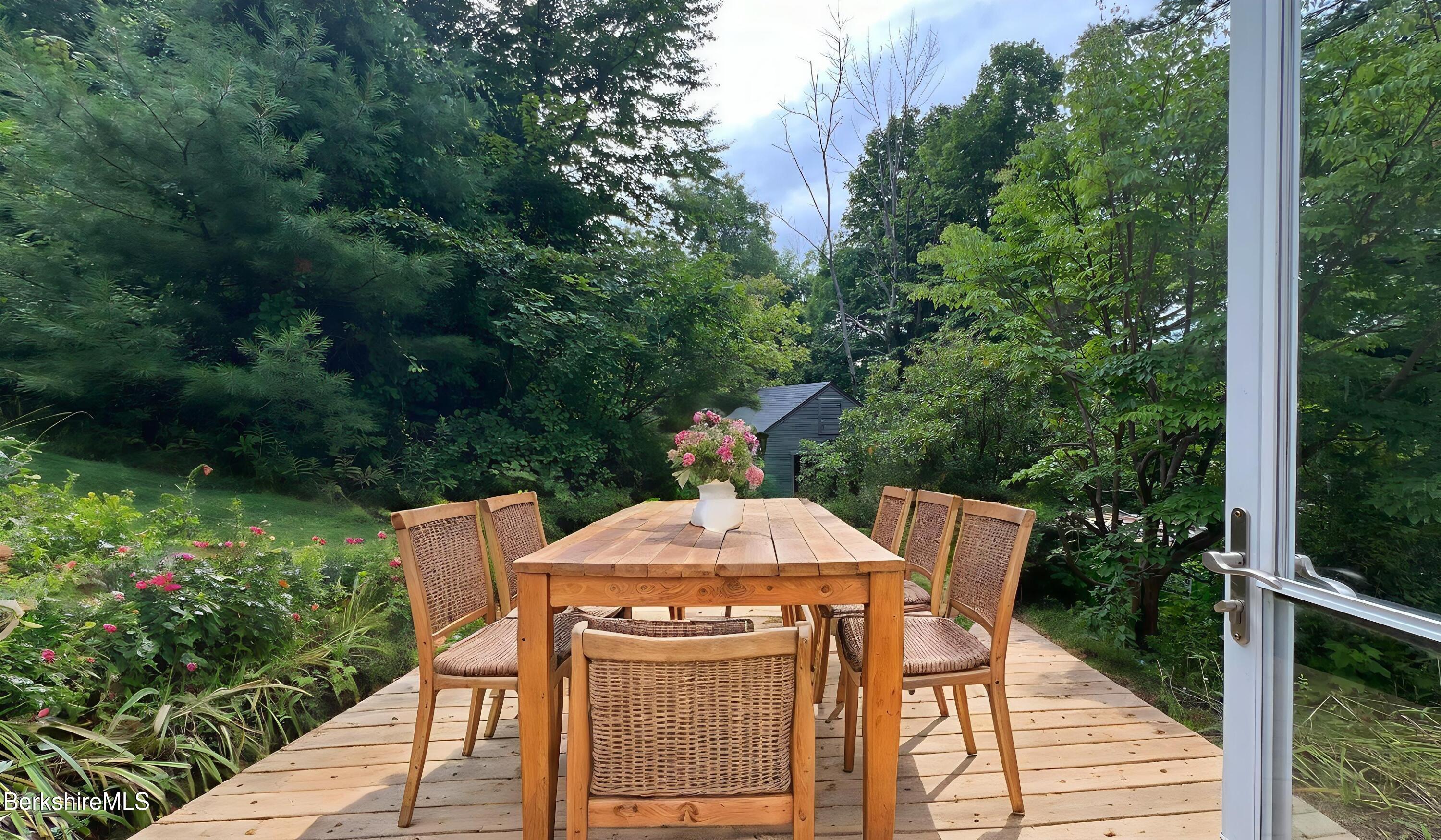 190 Willow Street Lee, MA 01260 - Photo 8 of 48 a view of a wooden deck with table and chairs a barbeque with potted plants and big trees