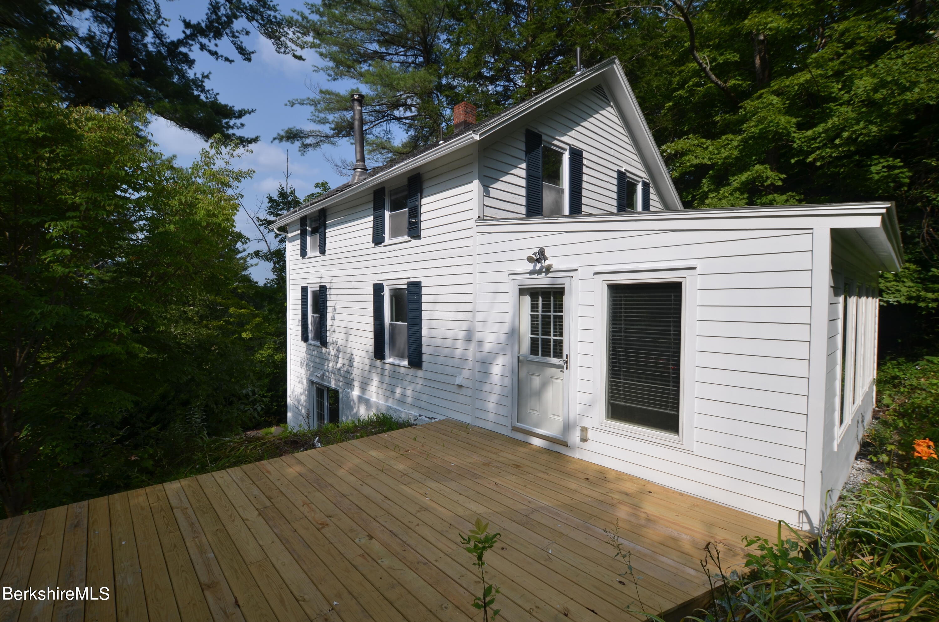 190 Willow Street Lee, MA 01260 - Photo 9 of 41 a front view of a house with a yard and garage