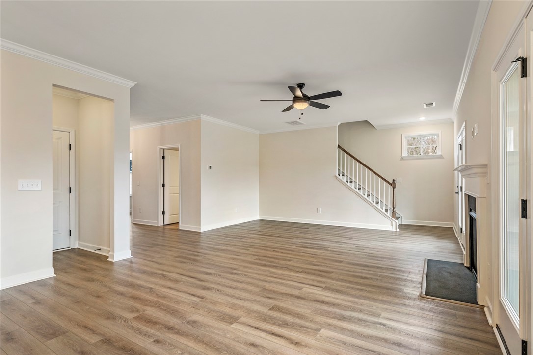 3140 Midway Road Anderson, SC 29621 - Photo 9 of 39 This expansive great room seamlessly connects living and entertaining spaces, featuring elegant wood flooring and a classic fireplace.