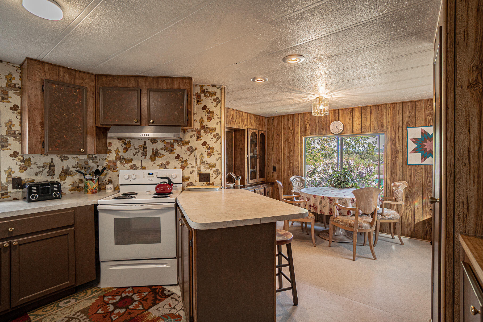 421 Stevens Road, Unit 26 Eagle Point, OR 97524 - Photo 5 of 23 a kitchen with a sink stove and cabinets