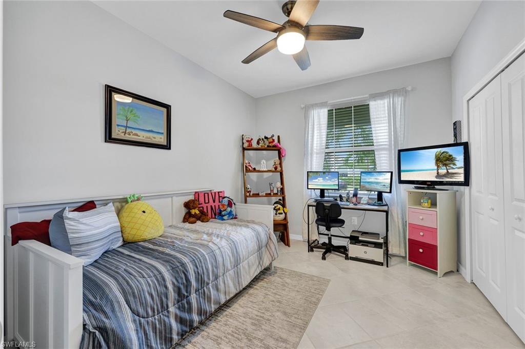 2622 Scarlet Way Naples, FL 34120 - Photo 13 of 24 a bedroom with furniture and a flat screen tv