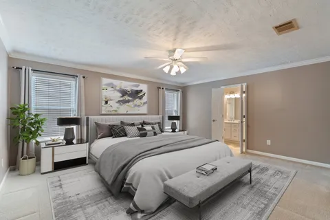 a bedroom with a large bed and a chandelier