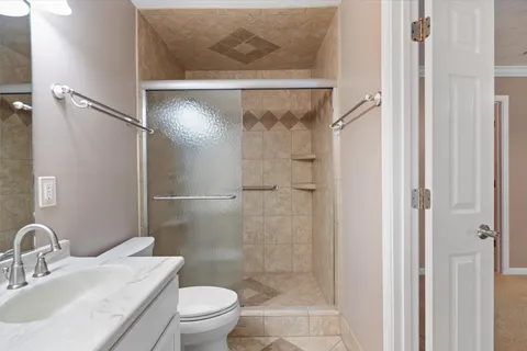 a bathroom with a sink toilet and shower