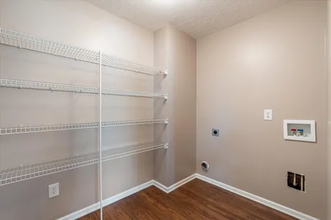 a view of a room with wooden floor