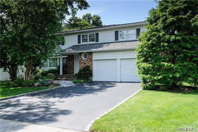 40 Ridge Road Searingtown, NY 11507 - Photo 1 of 1 a front view of a house with a yard and a garage