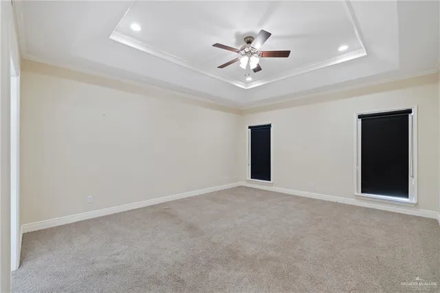 a view of an empty room with a chandelier fan