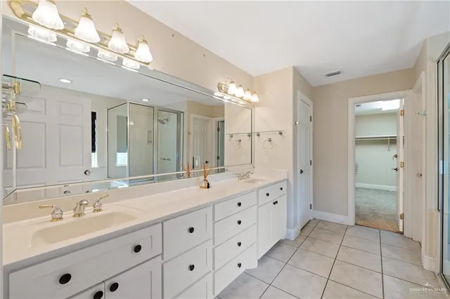 a spacious bathroom with a double vanity sink mirror and double