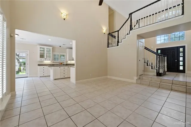 a view of a kitchen with white cabinets and a fireplace