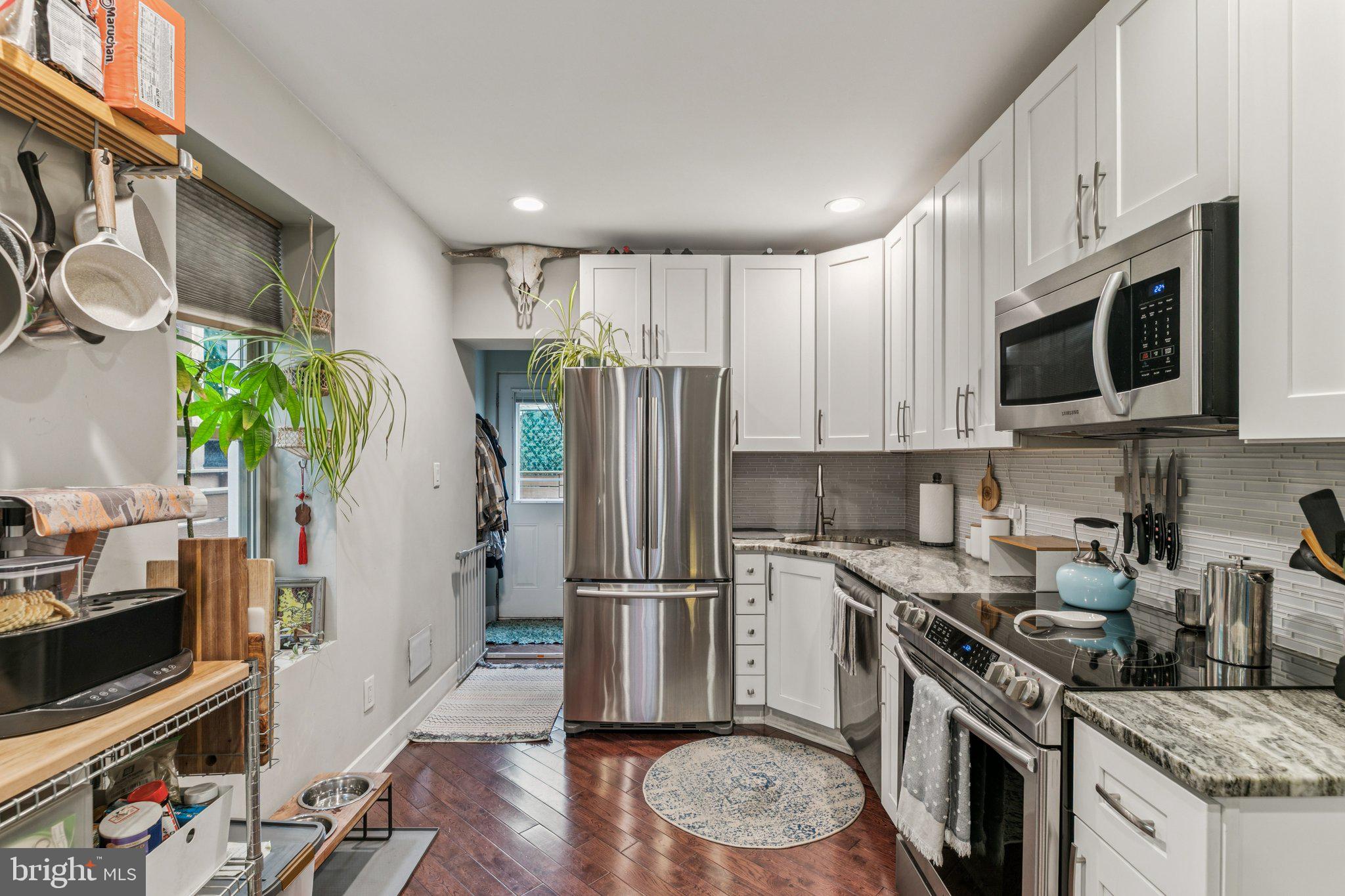 1314 North Dover Street Philadelphia, PA 19121 - Photo 12 of 30 a kitchen with stainless steel appliances granite countertop a refrigerator a stove a sink a microwave and cabinets