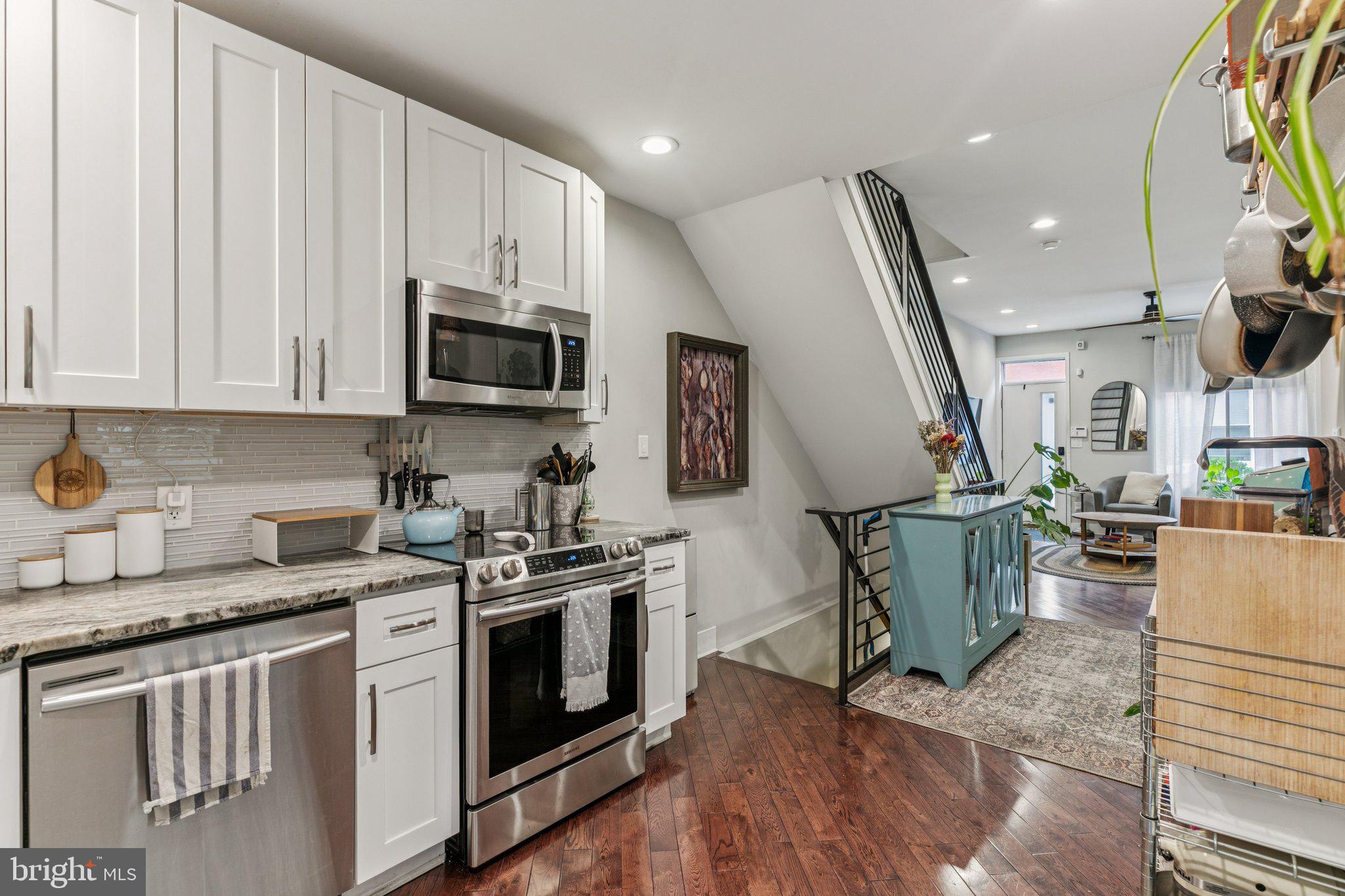 1314 North Dover Street Philadelphia, PA 19121 - Photo 13 of 30 a kitchen with a stove a sink and a microwave