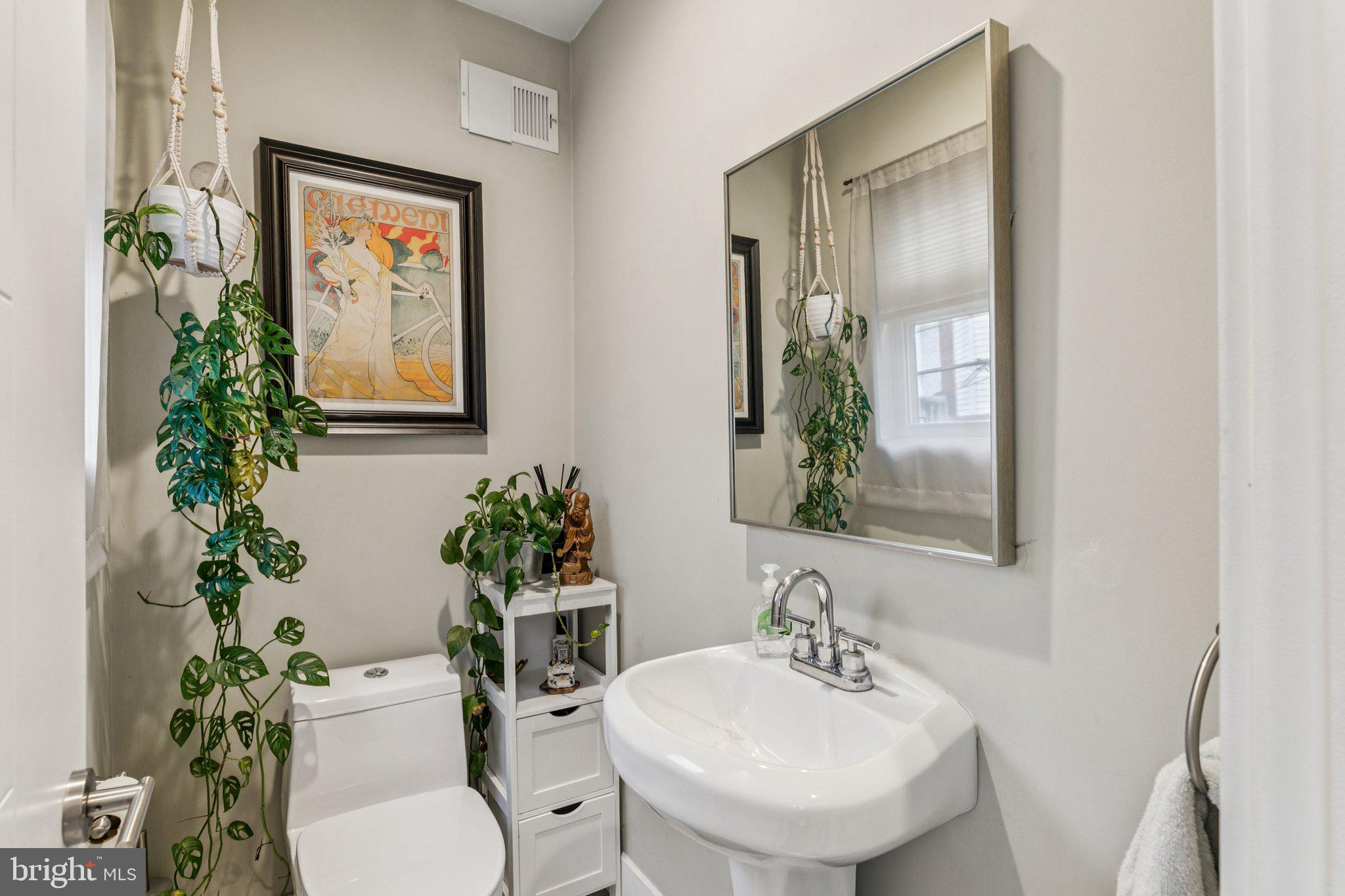 1314 North Dover Street Philadelphia, PA 19121 - Photo 15 of 30 a bathroom with a toilet sink and mirror