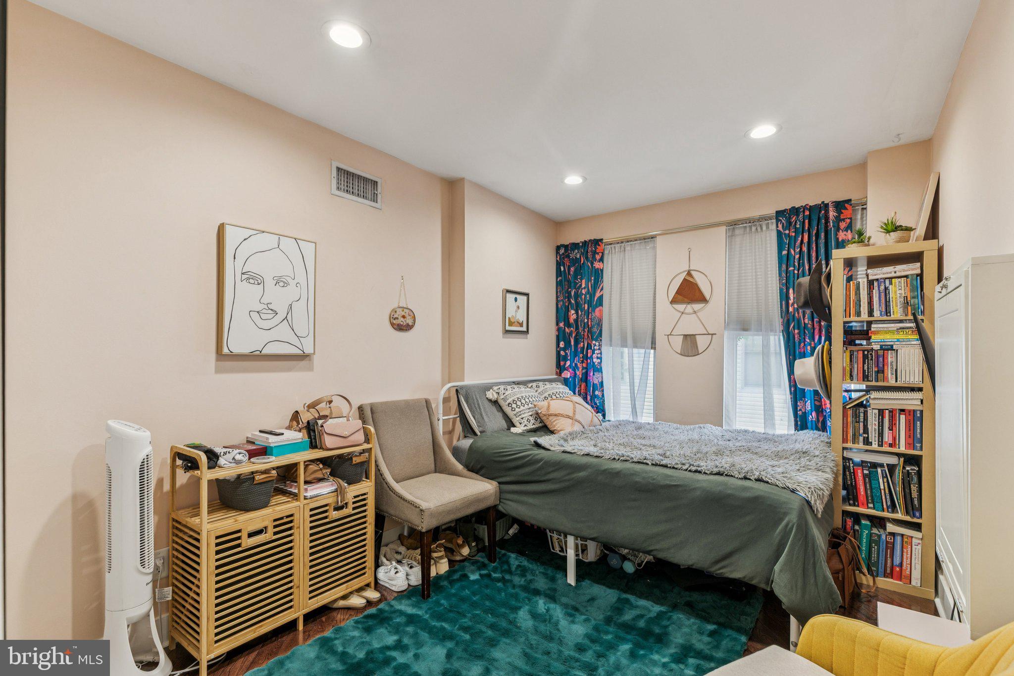 1314 North Dover Street Philadelphia, PA 19121 - Photo 17 of 30 a bedroom with a bed and a book shelf