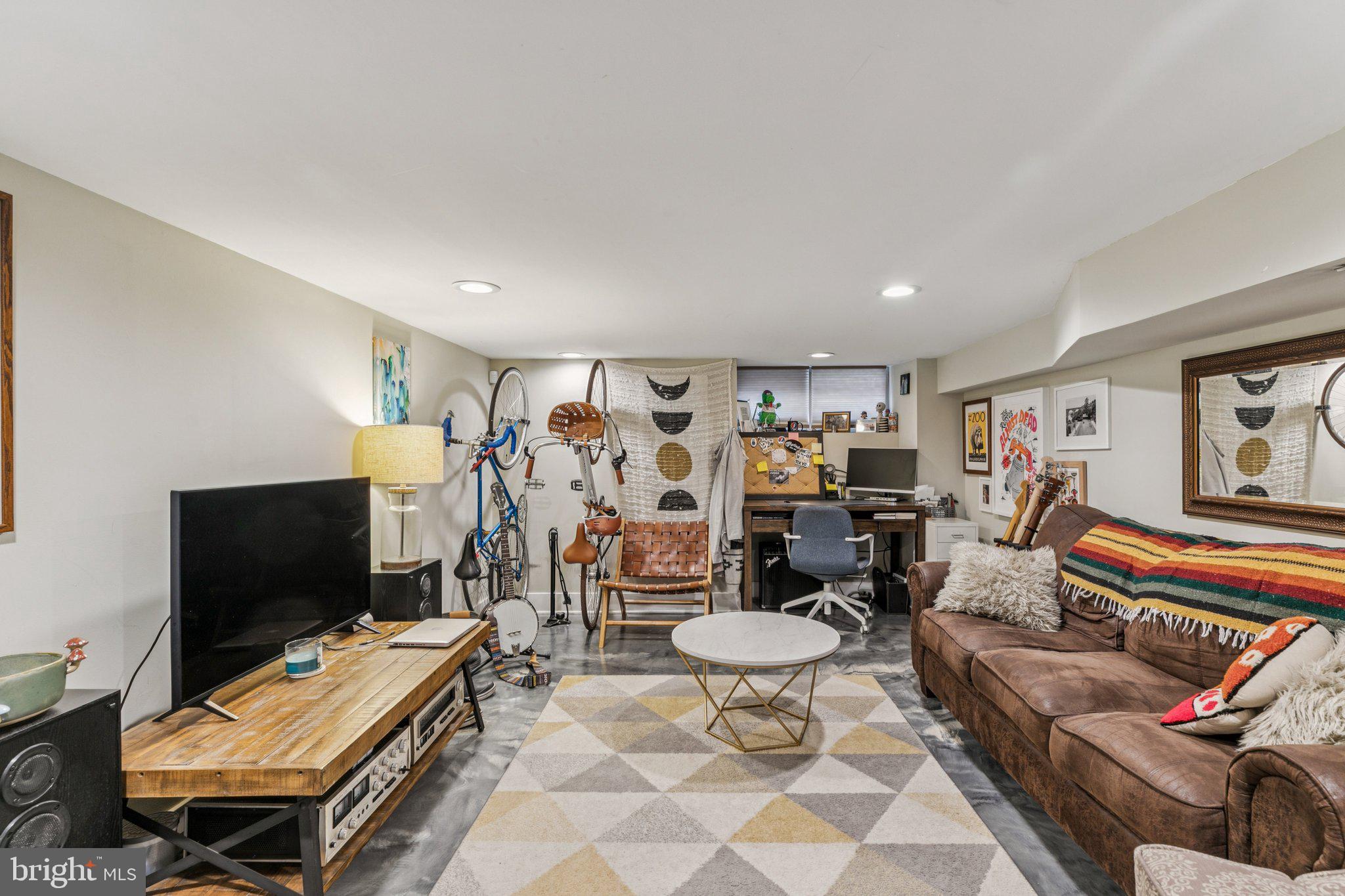 1314 North Dover Street Philadelphia, PA 19121 - Photo 27 of 30 a living room with furniture a flat screen tv and gym equipment