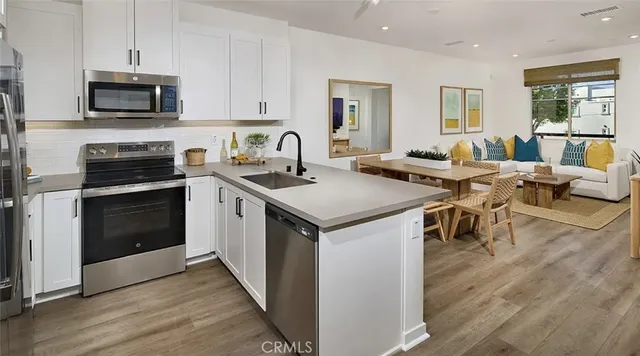 a kitchen with a stove sink and microwave