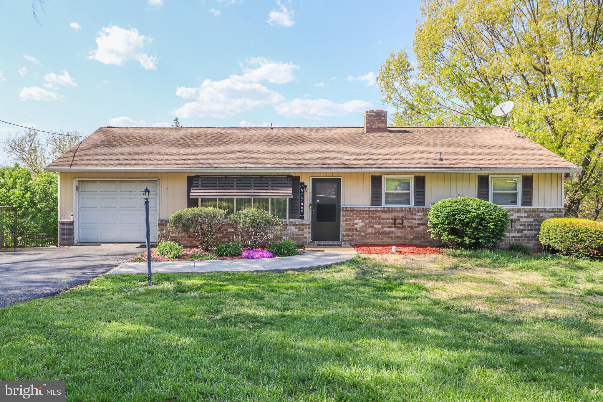 a view of a house with a yard and porch
