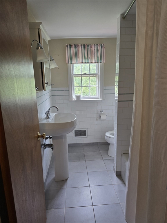 150 Grove Street Reading, MA 01867 - Photo 11 of 20 a bathroom with a sink toilet and window