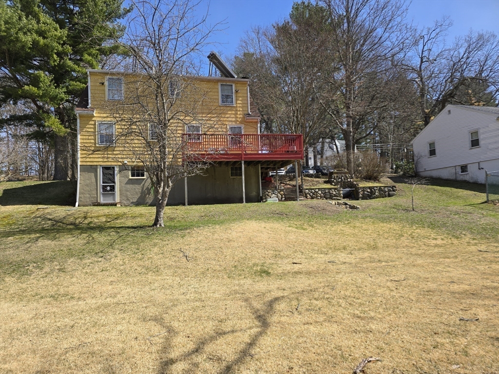 150 Grove Street Reading, MA 01867 - Photo 18 of 20 a front view of a house with a yard