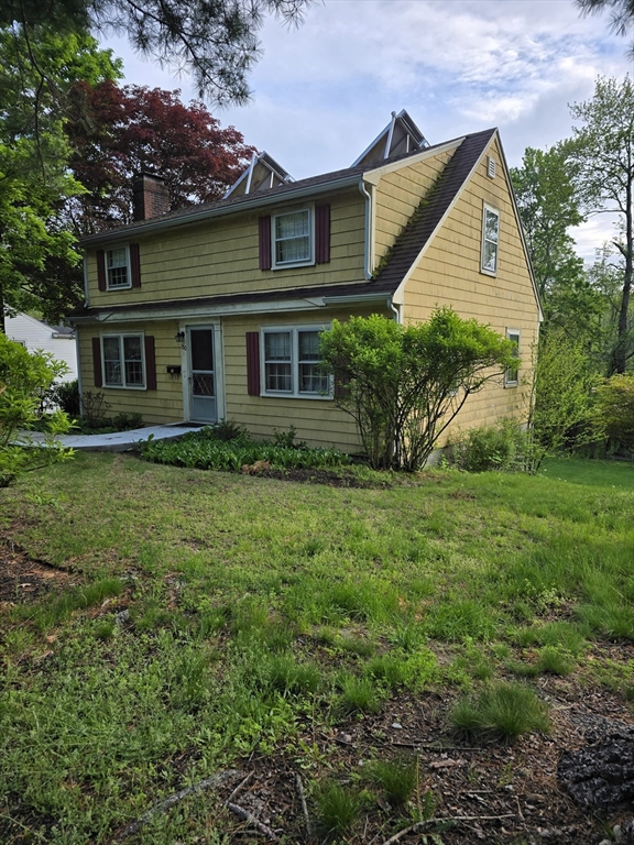 150 Grove Street Reading, MA 01867 - Photo 3 of 20 a front view of house with yard and green space